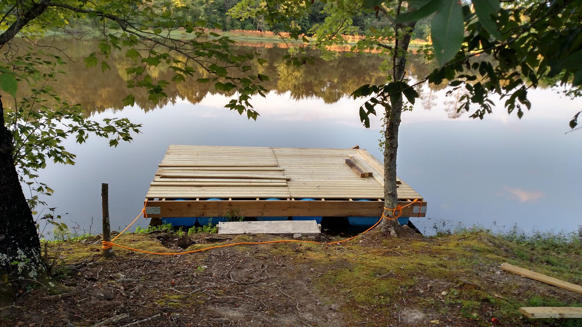 Wooden floating dock on the large pond